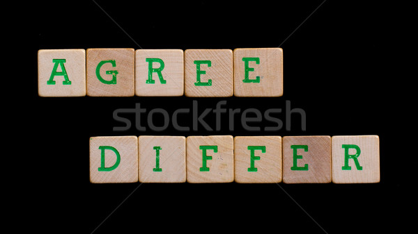 Letters on old wooden blocks (agree, differ) Stock photo © michaklootwijk