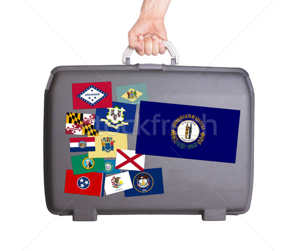 Stock photo: Used plastic suitcase with stains and scratches
