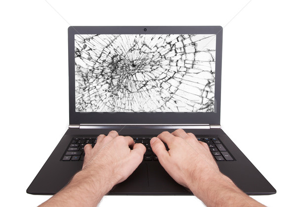 Man working on a laptop with a broken screen Stock photo © michaklootwijk