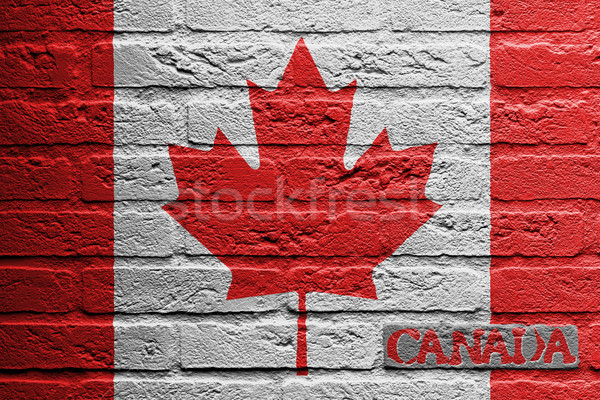 Stock photo: Brick wall with a painting of a flag