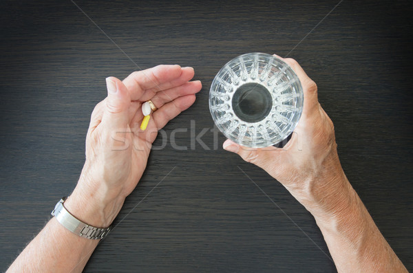 Elderly person taking medication Stock photo © michaklootwijk