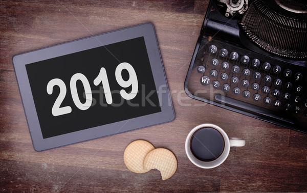 Tablet touch computer gadget on wooden table - 2019 Stock photo © michaklootwijk