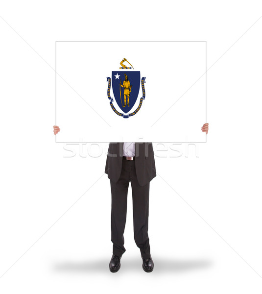 Stock photo: Smiling businessman holding a big card, flag of Massachusetts