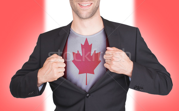 Businessman opening suit to reveal shirt with flag Stock photo © michaklootwijk