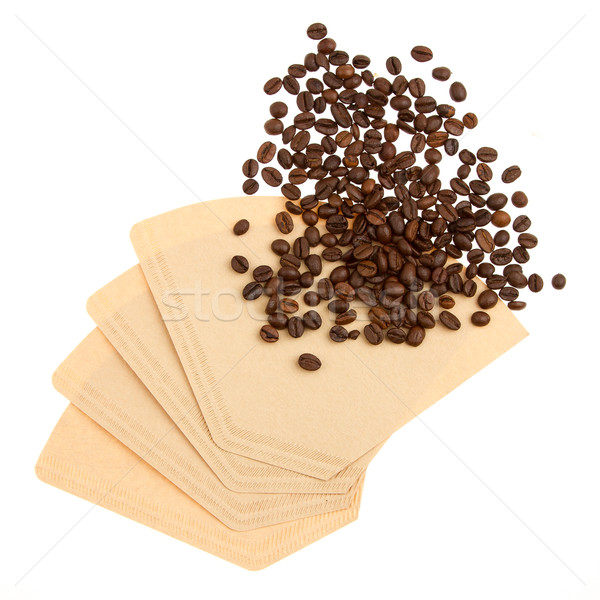 Coffee beans on a coffee filter (white background) Stock photo © michaklootwijk