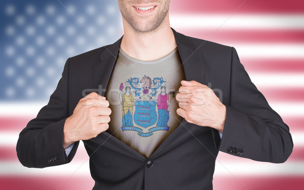 Businessman opening suit to reveal shirt with state flag Stock photo © michaklootwijk