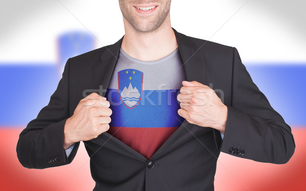 Businessman opening suit to reveal shirt with flag Stock photo © michaklootwijk