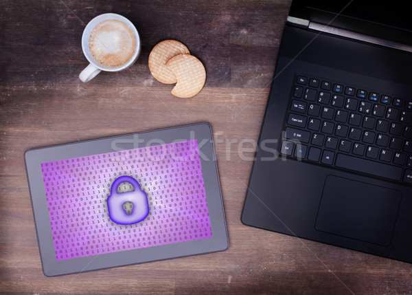 Tablet on a desk, concept of data protection Stock photo © michaklootwijk