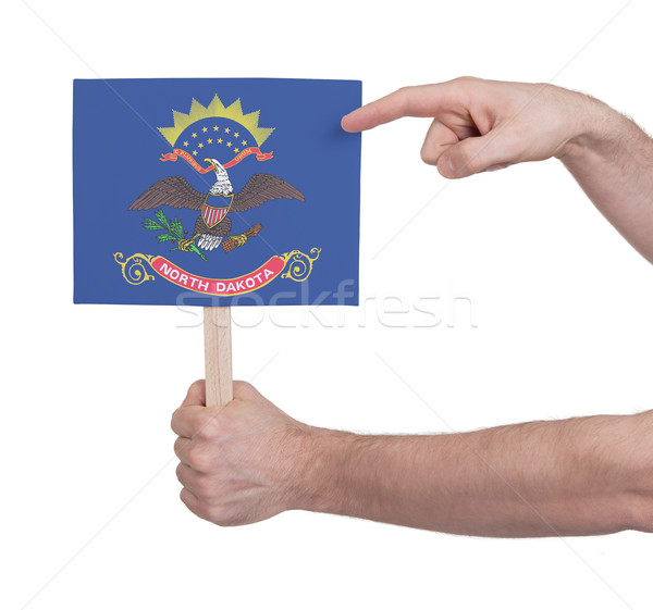 Hand holding small card - Flag of North Dakota Stock photo © michaklootwijk
