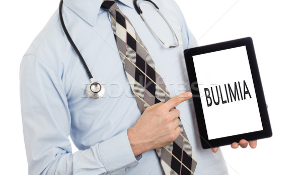 Orvos tart tabletta bulimia izolált fehér Stock fotó © michaklootwijk