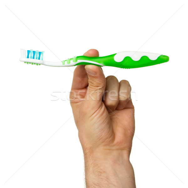Man holding a green toothbrush Stock photo © michaklootwijk