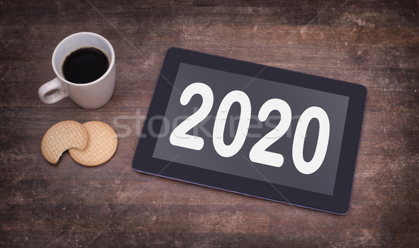 Tablet touch computer gadget on wooden table - 2020 Stock photo © michaklootwijk