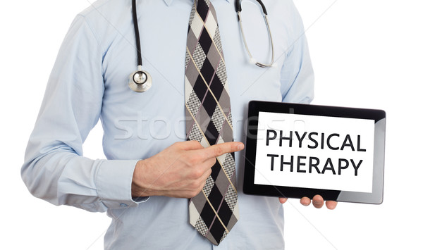 Doctor holding tablet - Physical therapy Stock photo © michaklootwijk