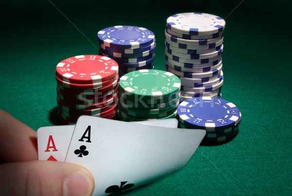 Looking at pocket aces during a poker game. Stock photo © mikdam