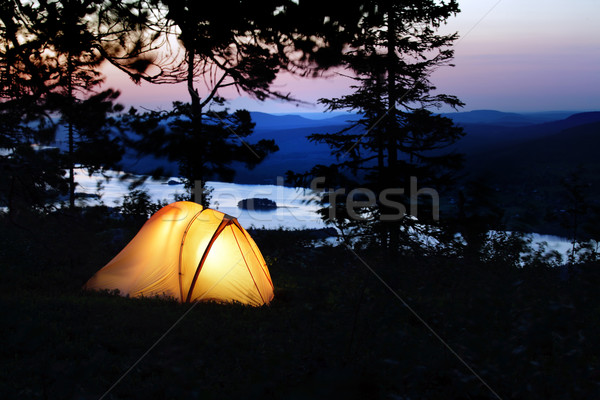 A tent lit up at dusk  Stock photo © mikdam