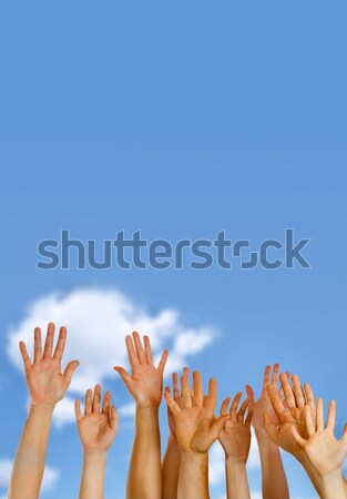 Hands raised up in air across blue sky  Stock photo © mikdam