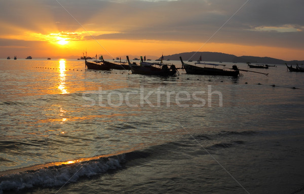 Stock photo: Longtail boats on seashore at sunset, Thailand