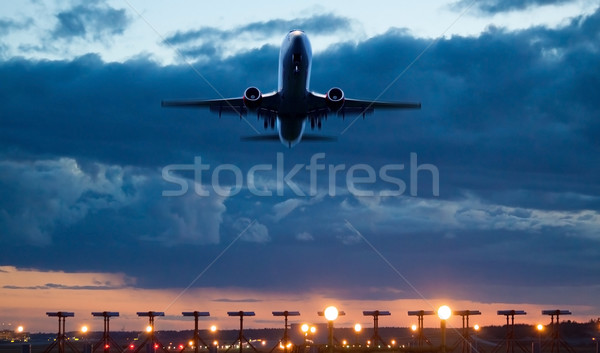Airplane take of at dusk Stock photo © mikdam