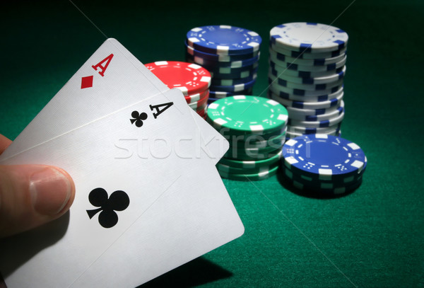 Stock photo: Looking at pocket aces during a poker game.