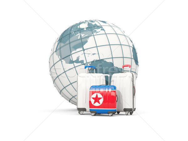 Luggage with flag of korea north. Three bags in front of globe Stock photo © MikhailMishchenko