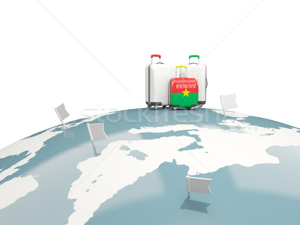 Luggage with flag of burkina faso. Three bags on top of globe Stock photo © MikhailMishchenko
