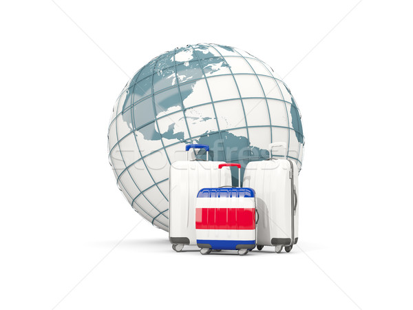 Luggage with flag of costa rica. Three bags in front of globe Stock photo © MikhailMishchenko