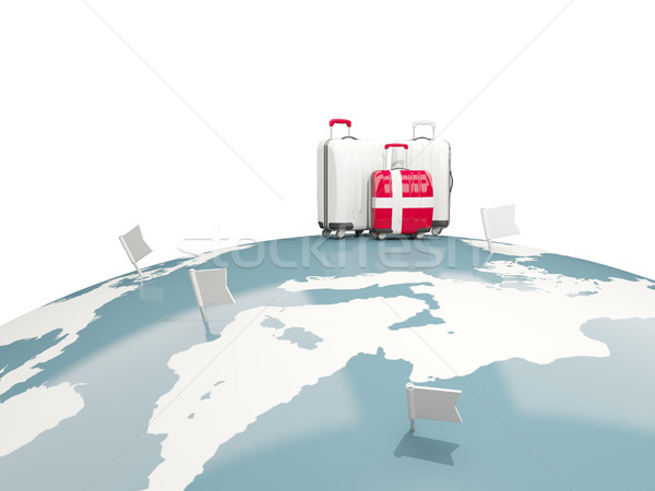 Luggage with flag of denmark. Three bags on top of globe Stock photo © MikhailMishchenko