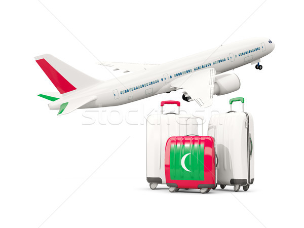 Luggage with flag of maldives. Three bags with airplane Stock photo © MikhailMishchenko