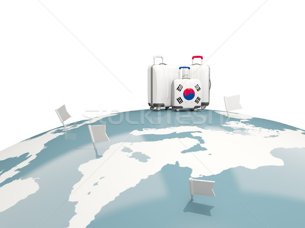 Luggage with flag of korea south. Three bags on top of globe Stock photo © MikhailMishchenko