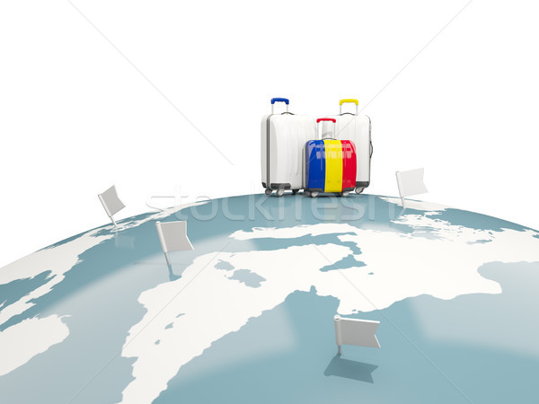 Luggage with flag of romania. Three bags on top of globe Stock photo © MikhailMishchenko
