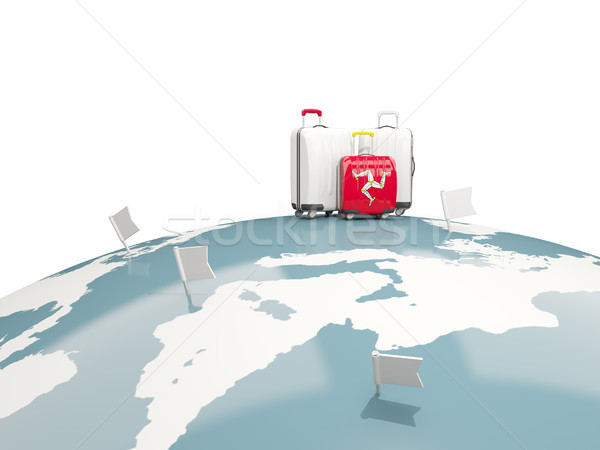 Luggage with flag of isle of man. Three bags on top of globe Stock photo © MikhailMishchenko