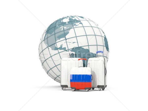 Luggage with flag of russia. Three bags in front of globe Stock photo © MikhailMishchenko