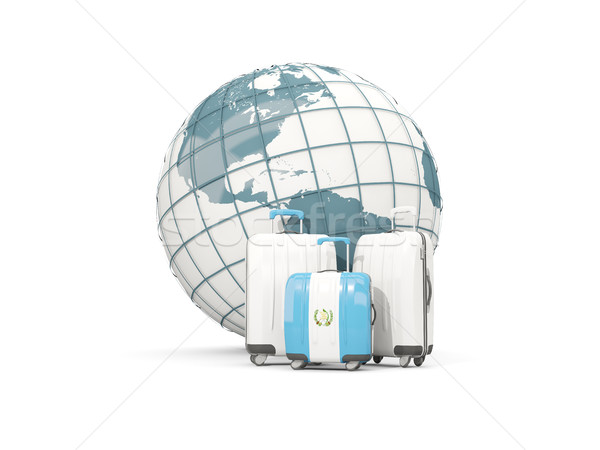 Luggage with flag of guatemala. Three bags in front of globe Stock photo © MikhailMishchenko