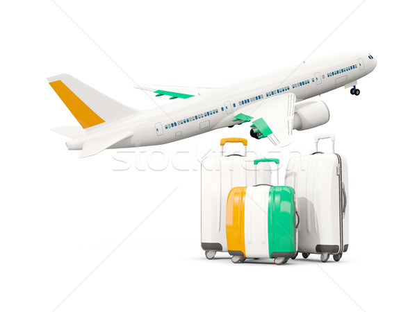 Luggage with flag of cote d Ivoire. Three bags with airplane Stock photo © MikhailMishchenko