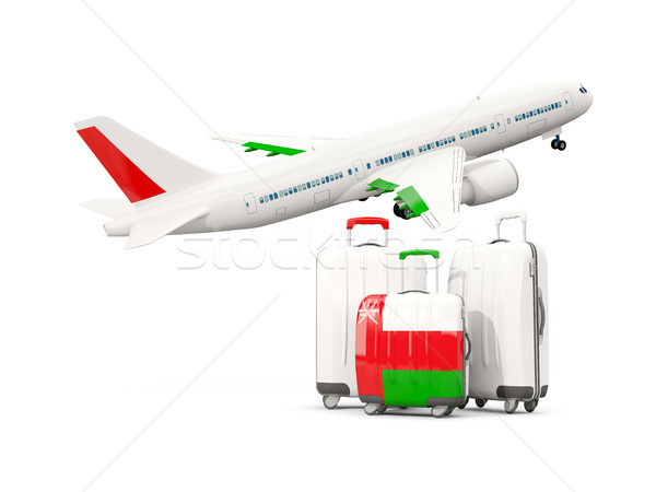 Luggage with flag of oman. Three bags with airplane Stock photo © MikhailMishchenko