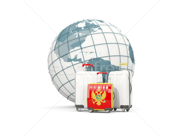 Luggage with flag of montenegro. Three bags in front of globe Stock photo © MikhailMishchenko