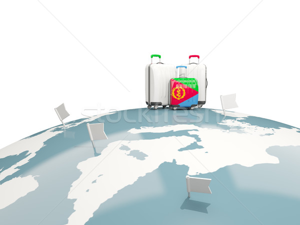 Luggage with flag of eritrea. Three bags on top of globe Stock photo © MikhailMishchenko