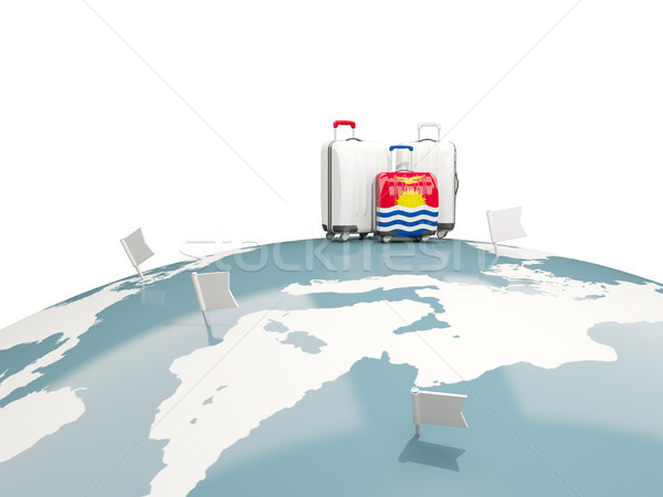 Luggage with flag of kiribati. Three bags on top of globe Stock photo © MikhailMishchenko