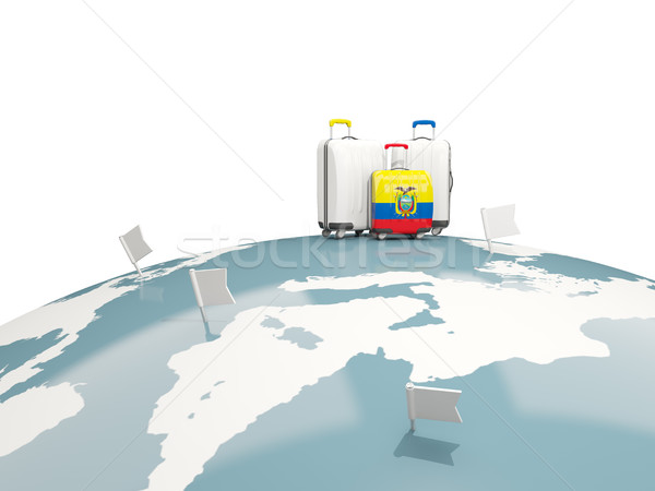 Luggage with flag of ecuador. Three bags on top of globe Stock photo © MikhailMishchenko