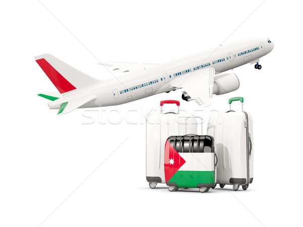 Luggage with flag of jordan. Three bags with airplane Stock photo © MikhailMishchenko