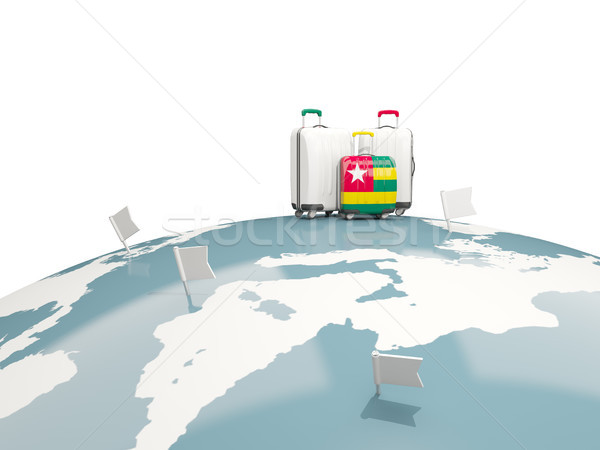 Luggage with flag of togo. Three bags on top of globe Stock photo © MikhailMishchenko