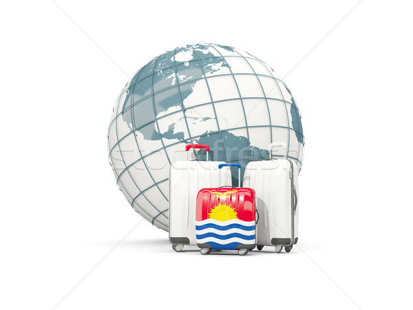 Luggage with flag of kiribati. Three bags in front of globe Stock photo © MikhailMishchenko