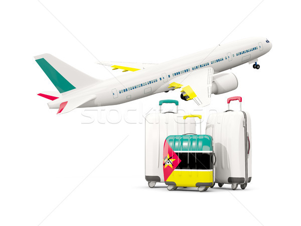 Luggage with flag of mozambique. Three bags with airplane Stock photo © MikhailMishchenko