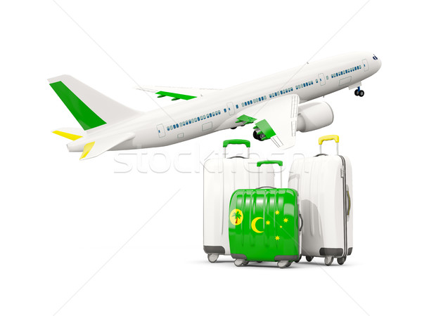 Luggage with flag of cocos islands. Three bags with airplane Stock photo © MikhailMishchenko