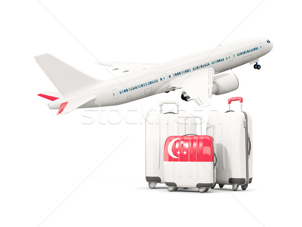 Luggage with flag of singapore. Three bags with airplane Stock photo © MikhailMishchenko