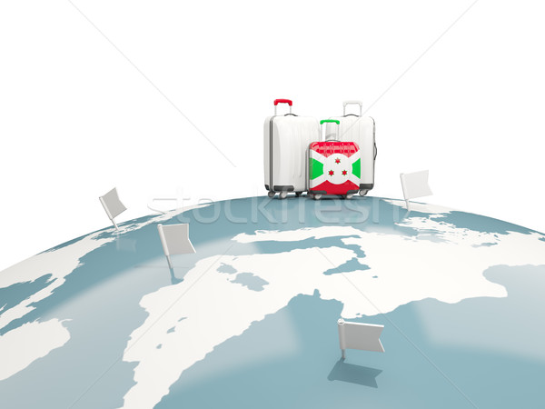 Luggage with flag of burundi. Three bags on top of globe Stock photo © MikhailMishchenko