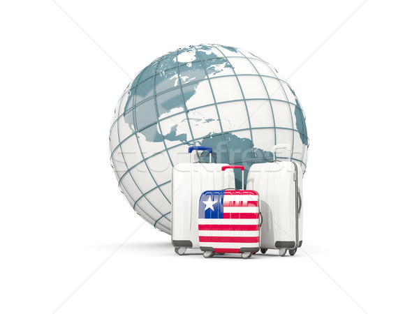 Luggage with flag of liberia. Three bags in front of globe Stock photo © MikhailMishchenko