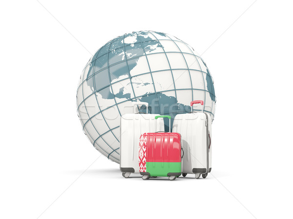 Luggage with flag of belarus. Three bags in front of globe Stock photo © MikhailMishchenko