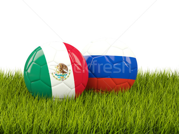 Two footballs with flags of Mexico and Russia on green grass Stock photo © MikhailMishchenko