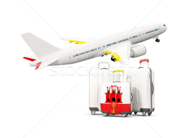 Luggage with flag of gibraltar. Three bags with airplane Stock photo © MikhailMishchenko